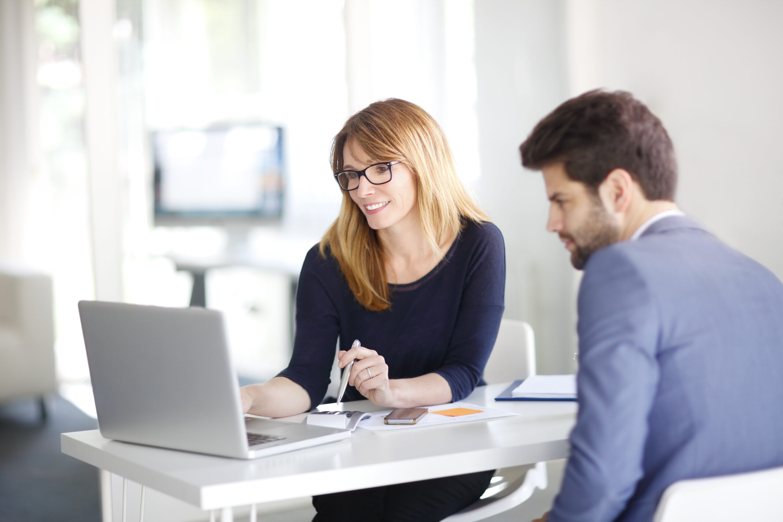 Portrait,Of,Investment,Advisor,Businesswoman,Sitting,At,Office,In,Front